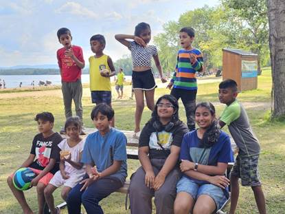 A group of children sitting on a bench
AI-generated content may be incorrect.